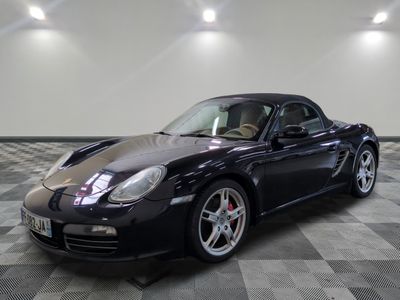 une photo d'une voiture de sport noire garée dans un garage