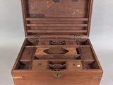 a small wooden box with several compartments inside of it