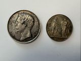 two silver coins with a woman and a man on them