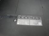a close up of a laptop with a battery on it