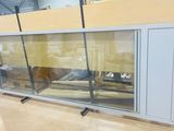 a glass display case with a television on it in a room