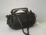 black leather handbag on white background with price tag
