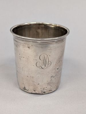 an antique silver cup with a monogram on the side