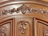 a close up of a wooden door with carvings on it