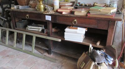 a wooden table with a bunch of books on top of it