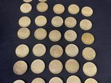 a close up of a pile of coins sitting on top of a table