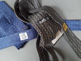 a blue tie and a blue and white tie on a table