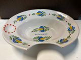 a white bowl with blue and yellow flowers on it