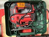 a red and black drill in a green case