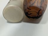 a hand that is holding a bottle and a jar