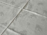 a close up of a bed with a white comforter on it
