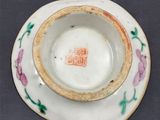 a small cup and saucer on a table