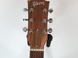 the headstock of an acoustic guitar with the gibson logo on it
