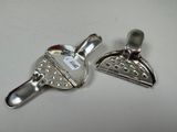 two silver spoons sitting next to each other on a table