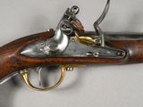 a close up of a gun on a table with a white background
