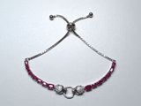 silver plated bracelet with pink beads and silver beads on a white background