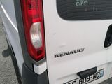 a white van parked in a parking lot with its door open