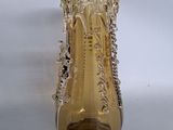 a glass vase with a chain around it on a white surface