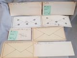 several envelopes are lined up on a blue sheet of paper