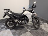a picture of a white and black motorcycle parked on a checkered floor