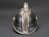 an old helmet is sitting on top of a black table