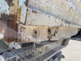 a close up of a truck with rust on the side of it