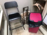 two chairs and a trash can in the corner of a room