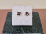 a close up of a pair of earrings sitting on top of a box