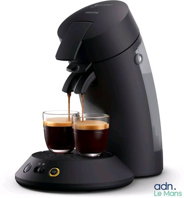 two cups of coffee being poured into a coffee machine