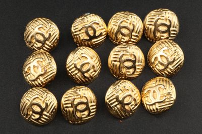 a close up of a bunch of gold colored beads on a black surface