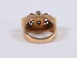 a close up of a gold ring with a diamond