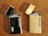 two lighters sitting on a table next to each other