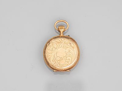 an old gold pocket watch with a chain on a white surface