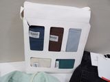 a box of clothes and a pair of jeans on a table