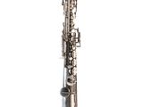 a close up of a silver saxophone on a white background