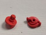 two red buttons that are on a white surface