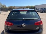 the back end of a black volkswagen golf parked in a parking lot