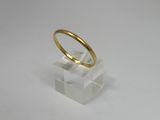 an image of a gold ring sitting on top of a clear block