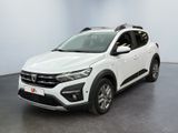 La voiture blanche est garée dans une pièce au sol noir.