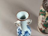 two small vases sitting next to each other on a table