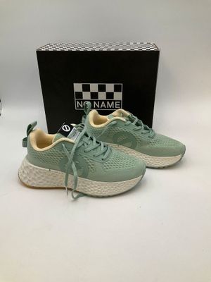 a pair of green sneakers sitting on top of a white table