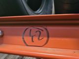 a close up of a truck with a tire on the back of it