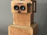 two wooden boxes that have binoculars on top of them