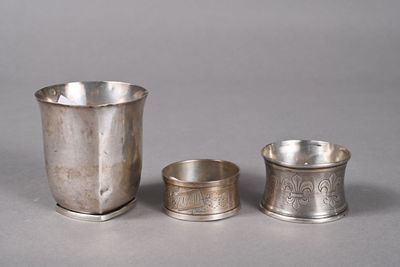 three silver cups sitting next to each other on a table