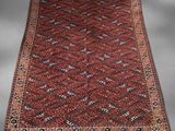 a red and black rug with geometric design