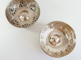 pair of silver plated bowls on a white background
