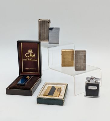 several different types of lighters and lighter cases sitting on a table
