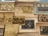 a lot of old photographs on the table