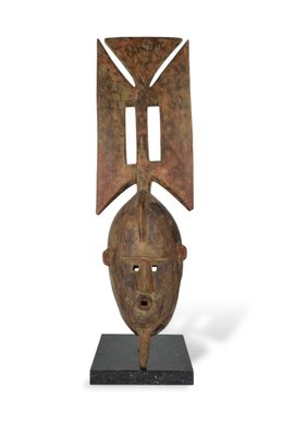 a wooden sculpture of a man ' s head on a black base