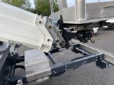 a white truck with a flat bed attached to it ' s trailer